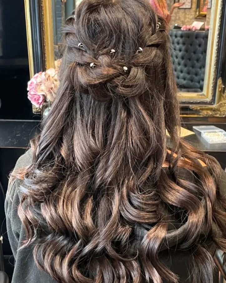 Long dark brown hair, twisted half-up with small bead-headed pins and loose curls below