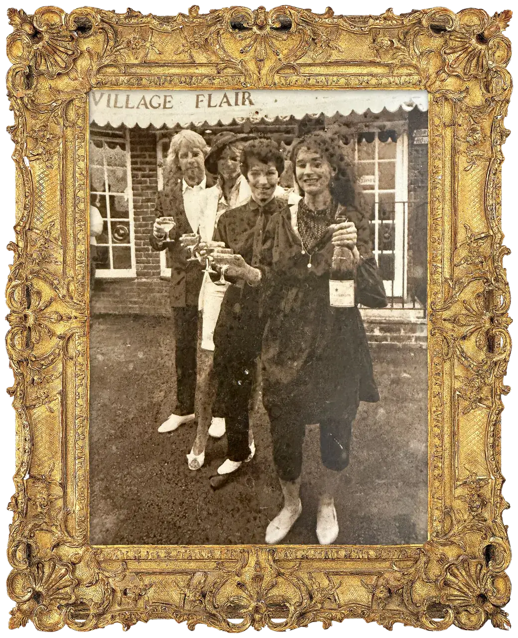 Opening day: Belinda and three others raise champagne glasses under an awning lettered Village Flair